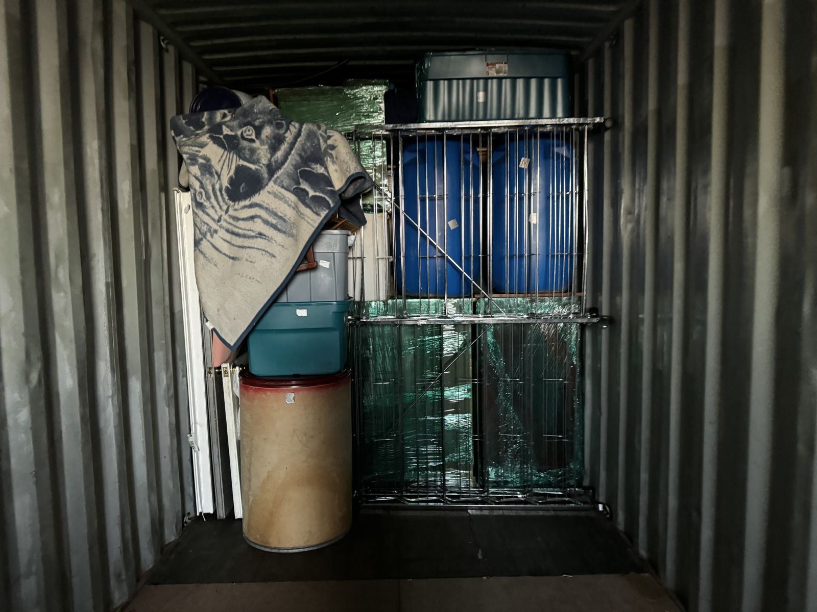 Drums and wrapped goods secured inside a container
