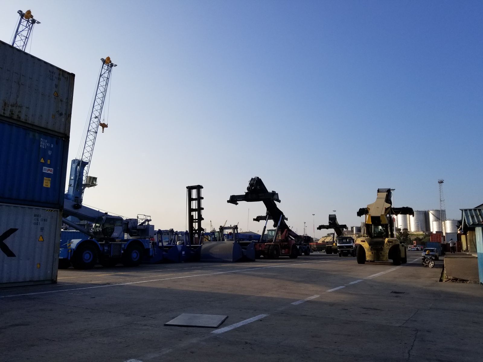 Reach stackers and cranes handling containers at the port
